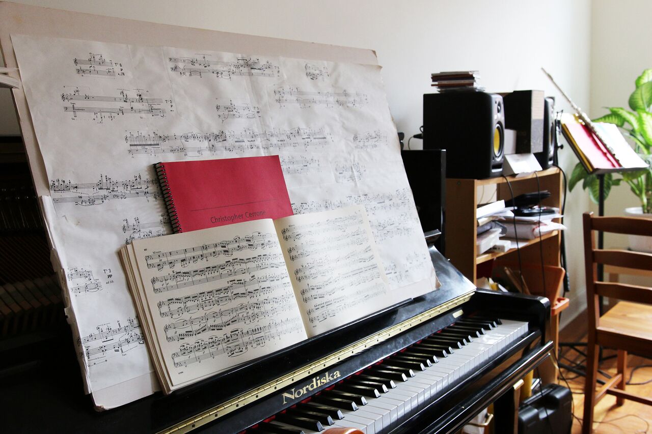 Three superimposed scores are propped up on Cerrone's piano, Stockhausen's Klavierstucke XI, an original composition, and a Beethoven sonata.